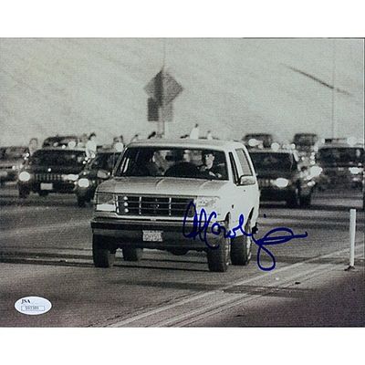 Al Cowlings signed photo. JSA Authenticated. Al Cowlings signed photo of OJ Simpson driving his 