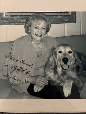 Betty White signed photo. Betty White photo autographed by Betty White and her dog Pontiac. 8x10 
