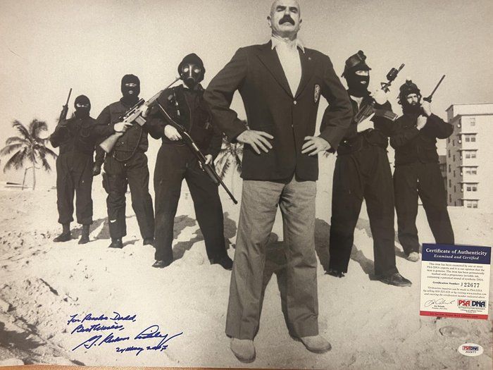Lot 289: G. Gordon Liddy signed photo. PSA