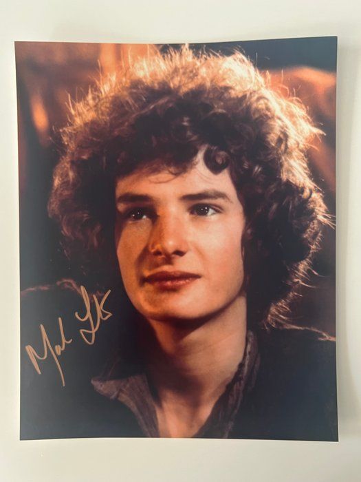 Lot 594: Crossed Swords Mark Lester signed movie photo