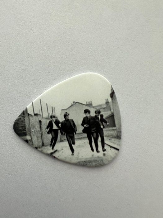 Lot 705: The Beatles guitar pick