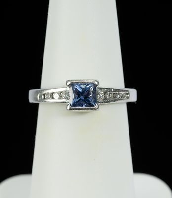 Platinum, Tanzanite Diamond Ring. DESCRIPTION: Platinum ring with central tanzanite flanked by 