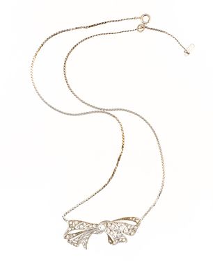 Antique 14K Gold Bow Pendant Necklace. A 16.5" chain and pendant necklace in 14k white gold. The 