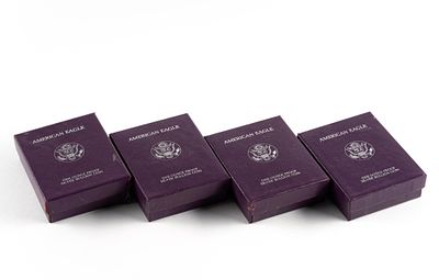 Four 1986-S Proof Silver American Eagles. The boxes and papers have some degradation but the 