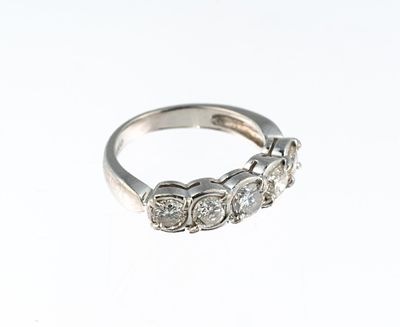 Platinum and Diamond Ring. A size 4 platinum ring with five round diamonds each approximately 