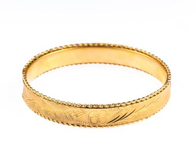 14K Gold Bangle. A yellow gold hinged bangle with inner dimensions of 2 3/8" X 2 1/4". The 