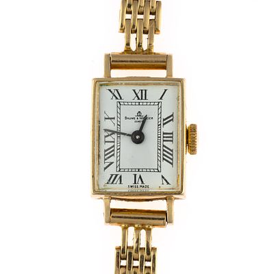14K Gold Baum & Mercier Wrist Watch. A vintage manual wind Baum & Mercier rectangular watch. The 