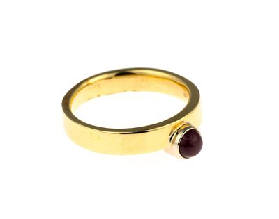 18K Gold and Ruby Ring. A size 6 yellow gold ring enhanced by a round cabochon ruby of 0.67 