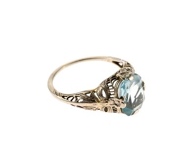 18K Gold and Gemstone Ring. A size 5.5 ring in white gold filigree with an oval faceted 