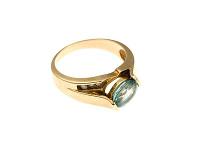 14K Gold Gemstone Ring. A size 7.5 ring with an oval blue topaz accented by six small diamonds. 