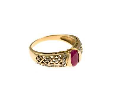 10K Gold, Ruby, and Diamond Ring. A size 6.5 yellow gold ring with faceted oval ruby and small 