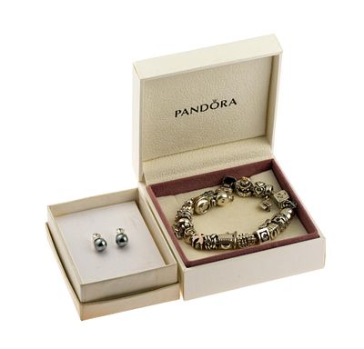 Sterling Silver Pandora Charm Bracelet. The charm bracelet is 7 1/2", loaded with charms, in the 