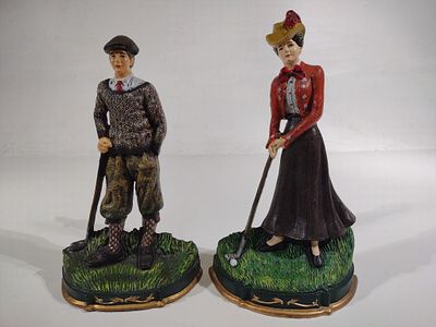 Pair of Cast Iron Golfer Doorstops. Man and woman painted cast iron golf figures. Each measures 