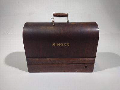Singer Traveling Sewing Machine. Serial number Y713666. With key. 17-1/8" wide x 12-1/2" high.