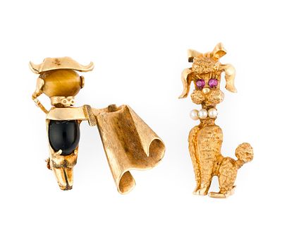 14K Gold Brooches. Two yellow gold brooches, poodle and conquistador. Both have gemstone 
