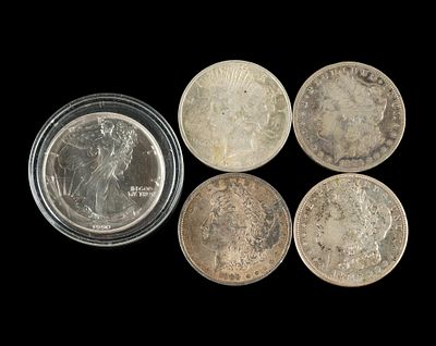 Four Silver Morgan And Peace And One Silver Merican Eagle Dollar. Three of the silver dollars 
