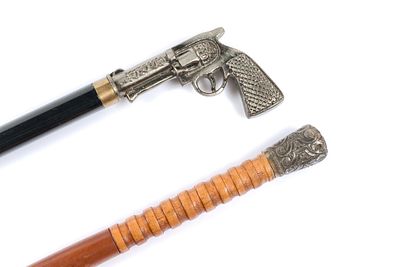 2 Cane Swords With Metal Handles. 1 cane has metal pistol shaped handle and 1 is a wooden cane 