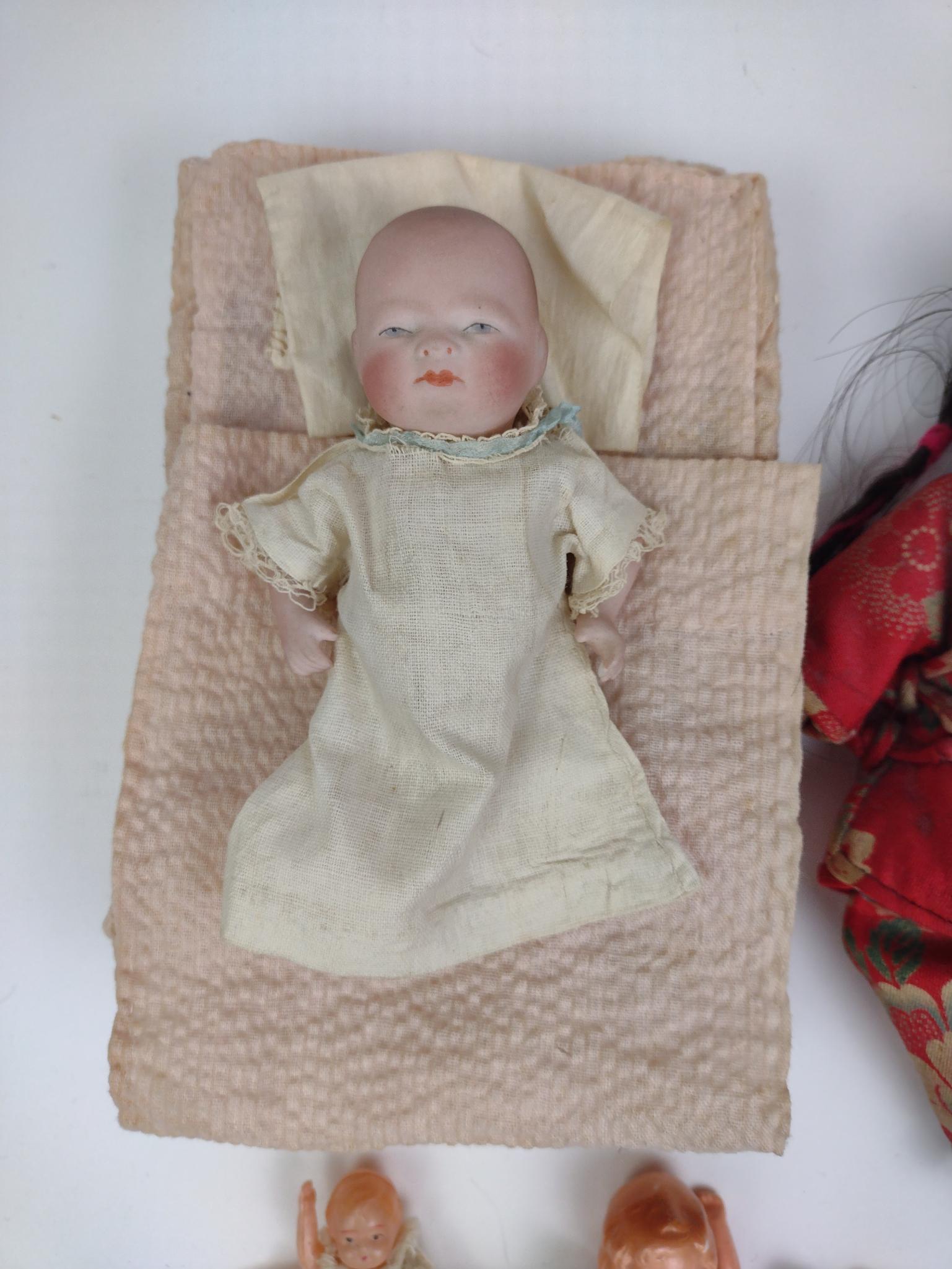 4 Miniature Dolls