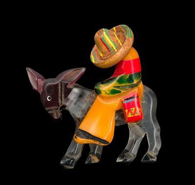Bakelite and Lucite Sleepy Rider Novelty Brooch. 2-1/2" wide x 2-1/2" long.