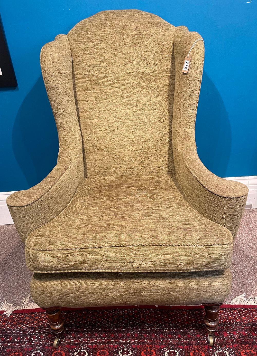 Lot 272 – A Queen Ann Style Wing Back Chair With Sweeping Arms And On Brass Casters