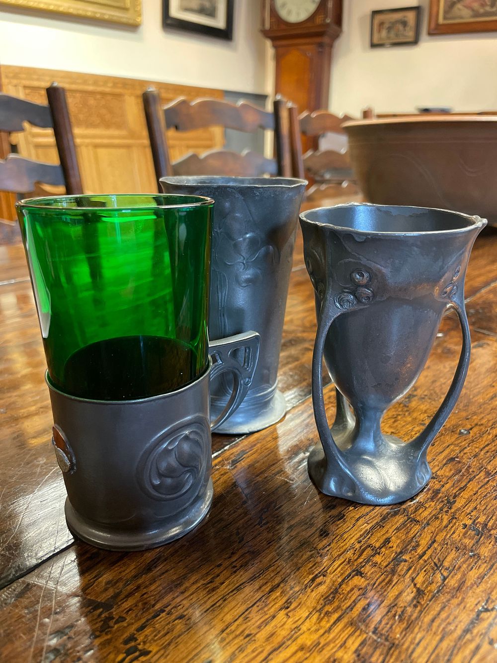Lot 308 – An Art Nouveau Pewter Cup Holder designed by Archibald Knox for Liberty and Co., in the Tudric range. Plus two other collectable Art Nouveau pewter designs from the range, the Orivit, and Kayserzinn.
