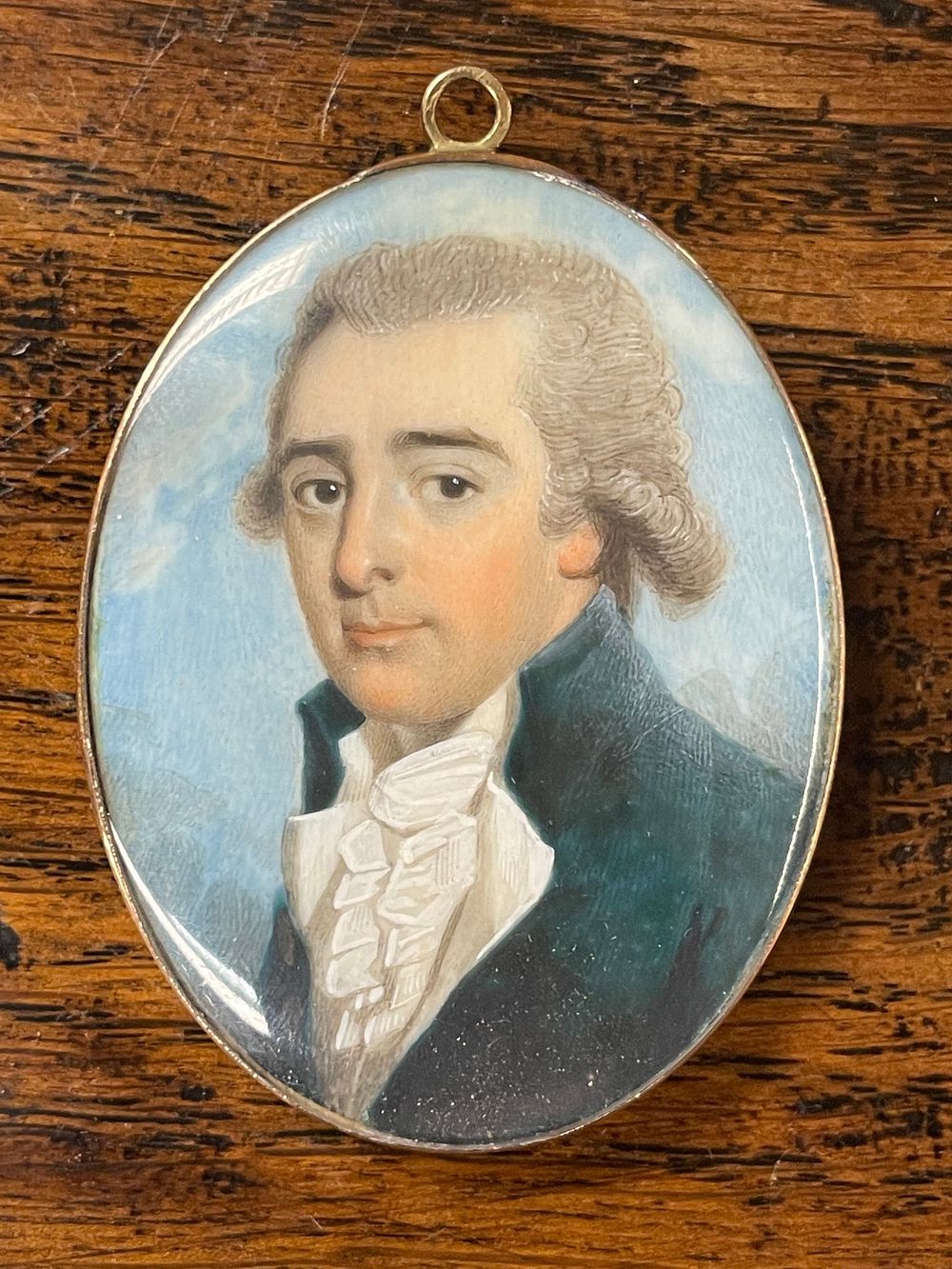 Lot 337 – A George III Portrait Miniature Pendant with Hairwork Reverse