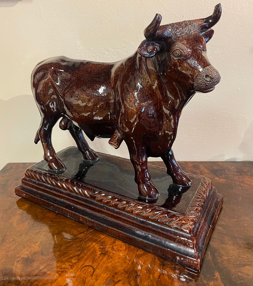 Lot 365 – A Portuguese Majolica Brown Glazed Model of a Bull, Late 19th Century
