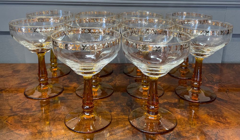 Lot 263 – Set of TenAmber-Stemmed Champagne Coupes with Gilded Leaf Rims
