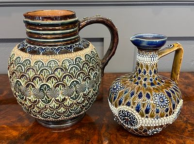Two Doulton Lambeth Salt-Glazed Stoneware Pitchers. This lot includes two Victorian-era Doulton 