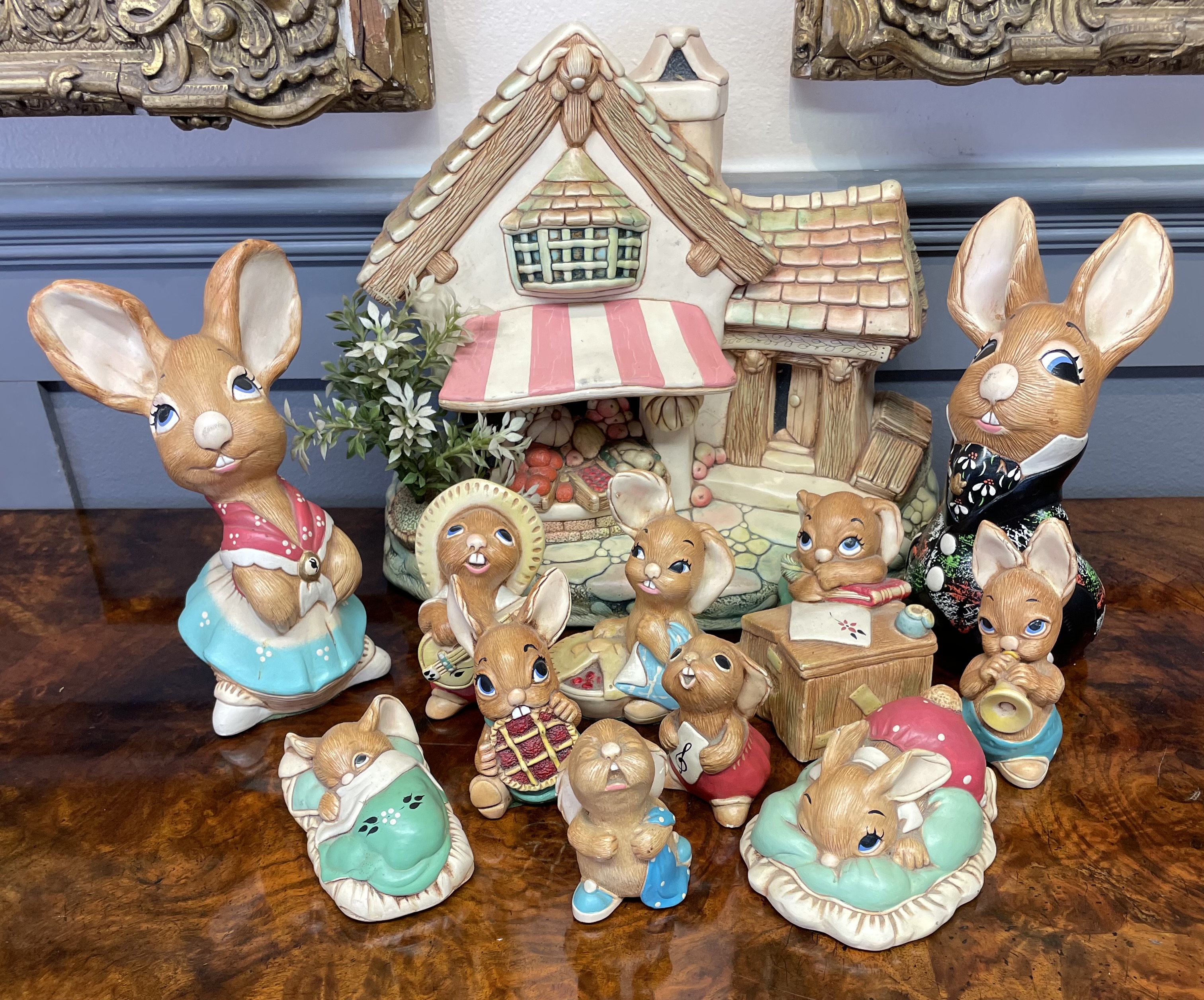 A 12-Piece Set of Mid-Century Anthropomorphic Ceramic Rabbit Figurines and Cottage Centerpiece