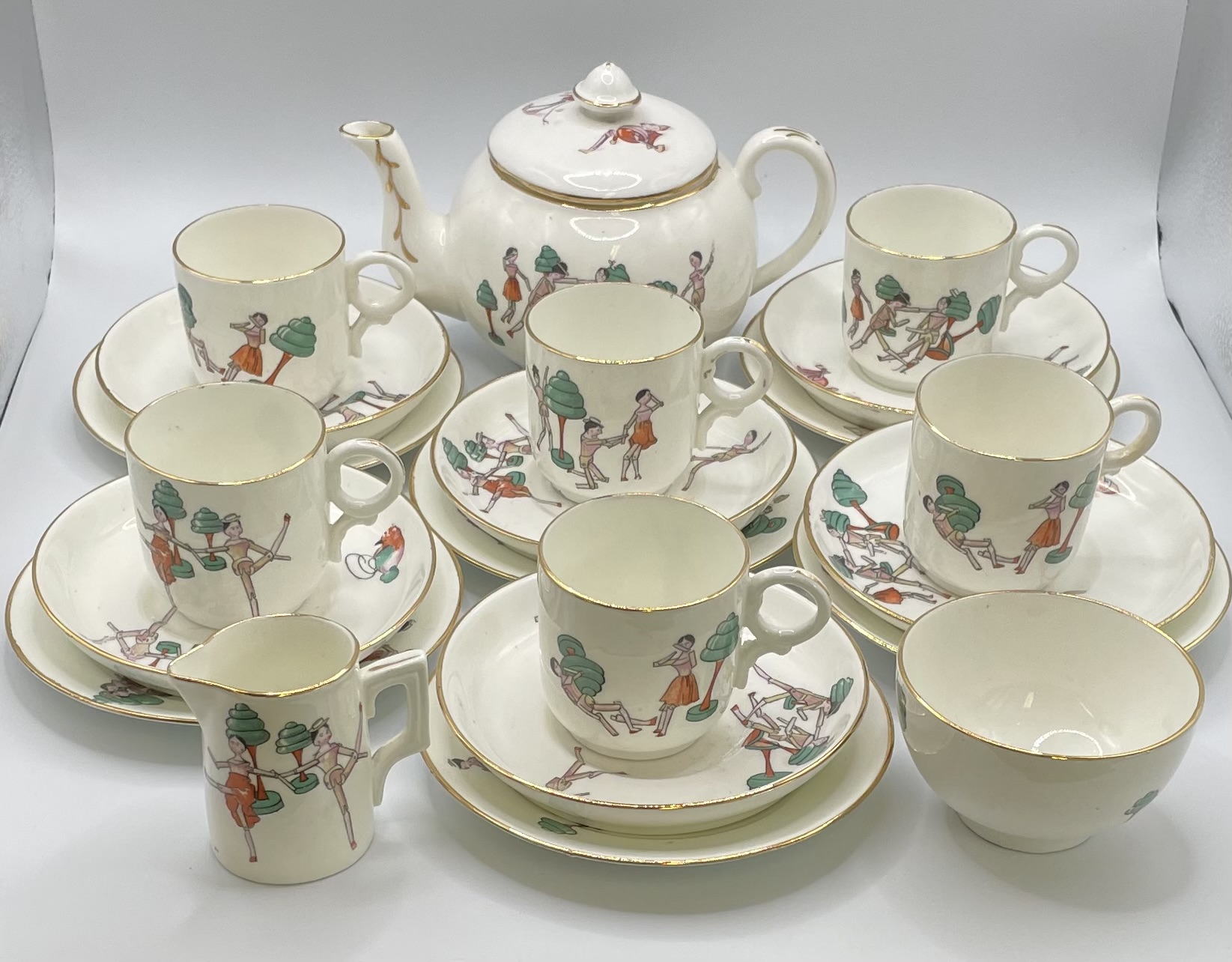A Childtens Art Deco Ceramic Tea Set with Dutch Peg Doll Figurative Decoration