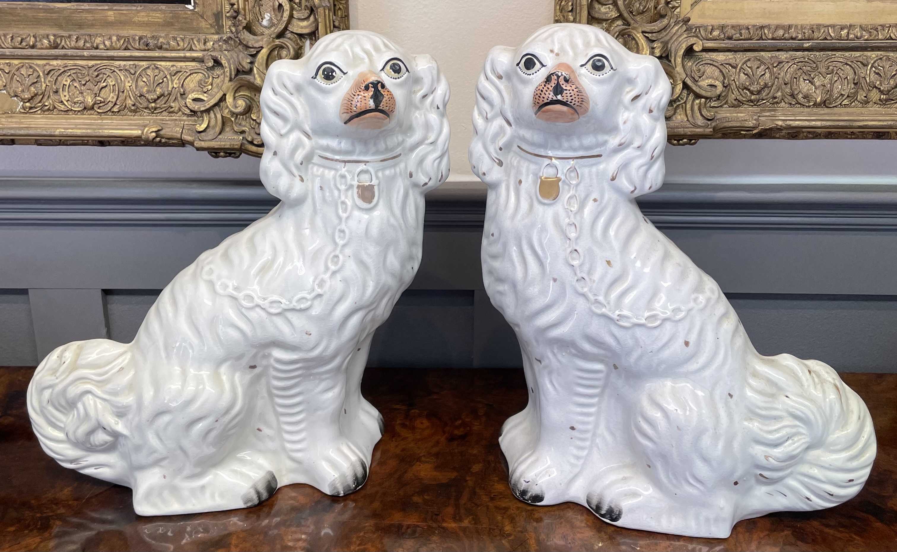 A Pair of Victorian Staffordshire White Glazed Spaniel Dogs