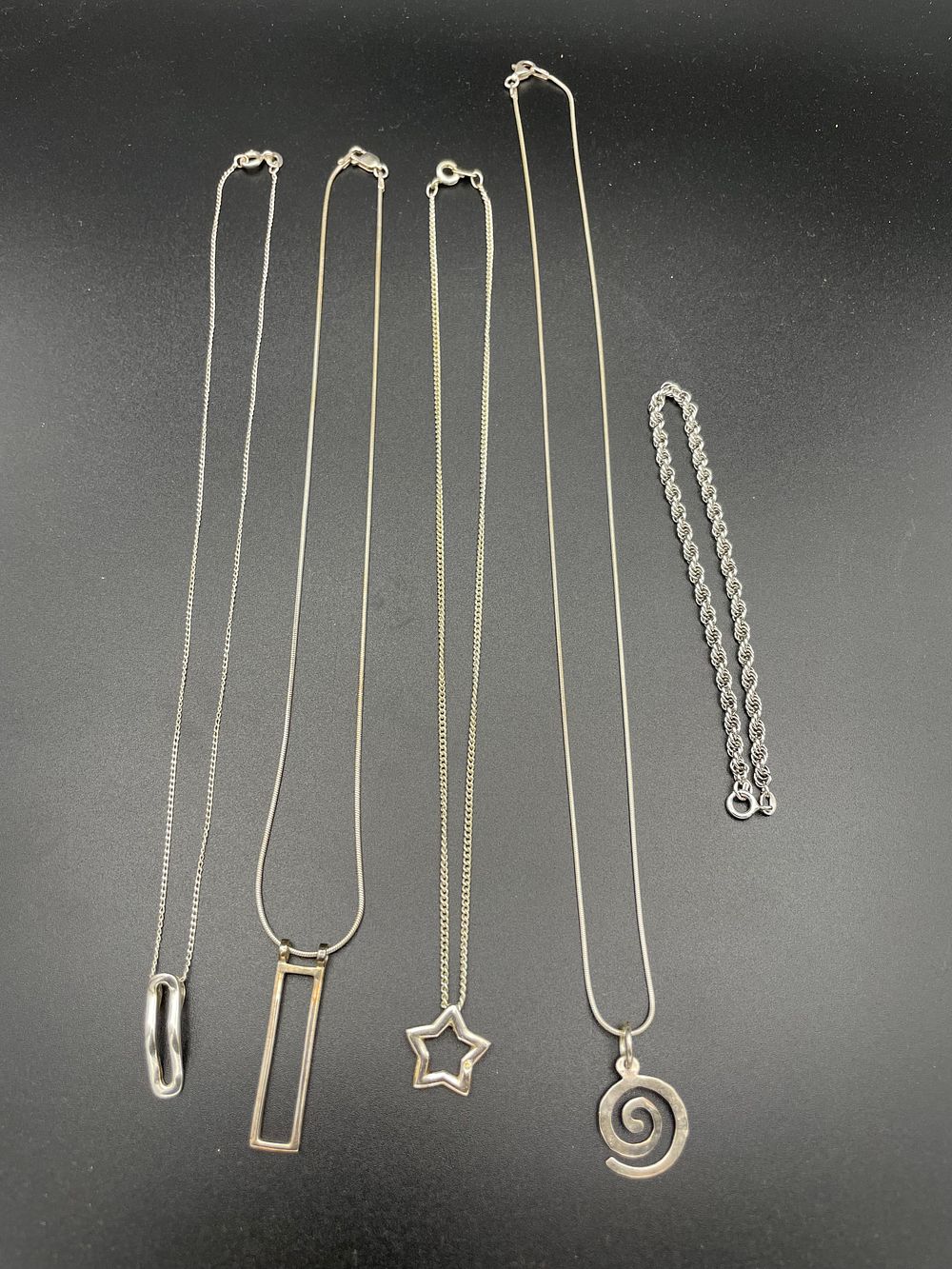 Lot 103 – A Collection of Silver Toned Jewelry Including Necklaces and a Bracelet