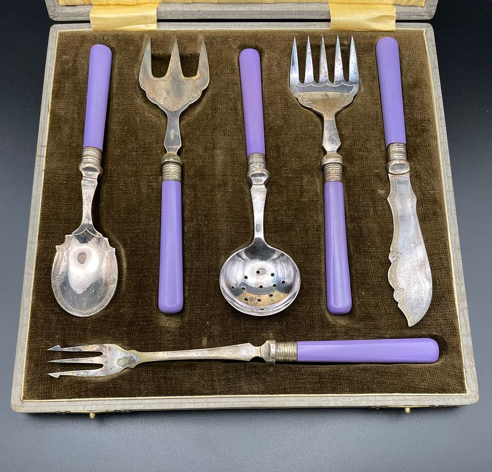 Lot 158 – A Set of Electroplated Nickel Silver Serving Utensils with Amethyst Color Handles in Fitted Presentation Case