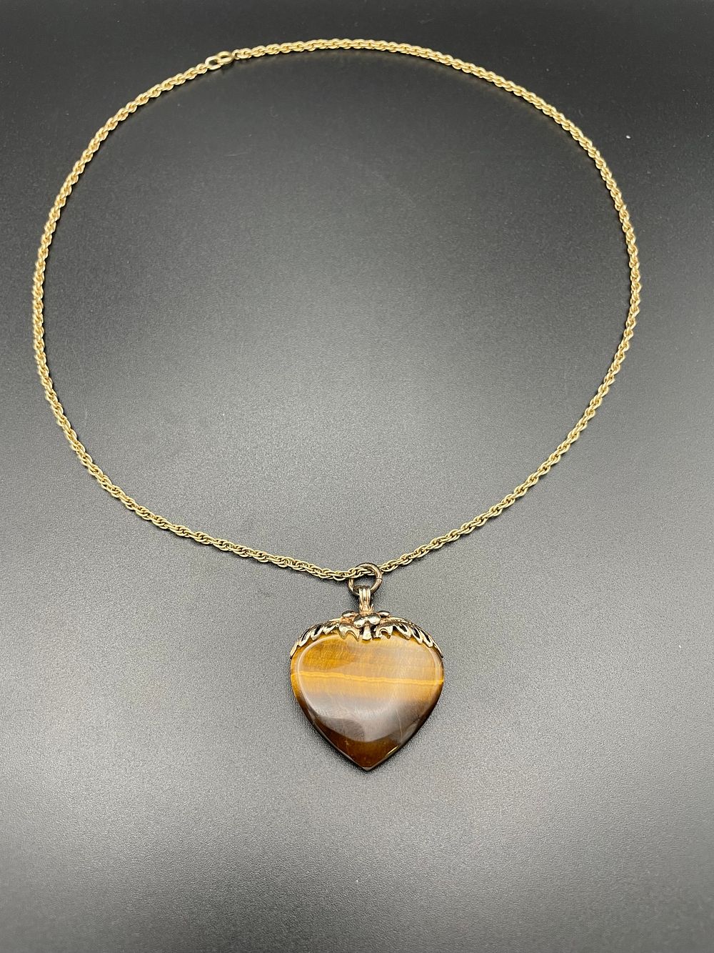 Lot 122 – 9 Karat Yellow Gold and Tiger Eye Heart Pendant on Rope Chain
