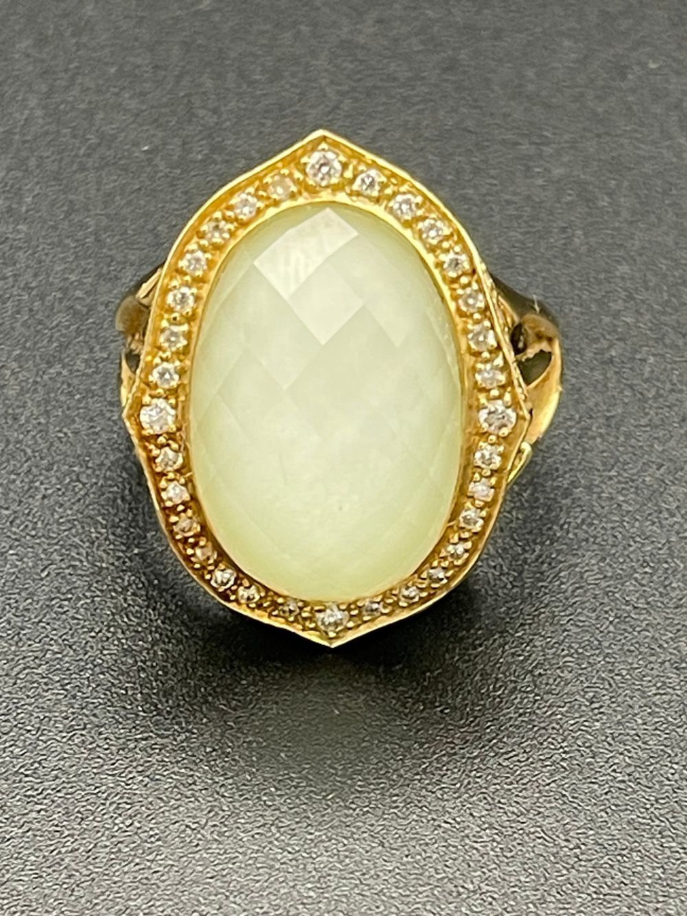 Lot 133 – 18K Yellow Gold Checkerboard Cut Pale Green Stone and Diamond Halo Cocktail Ring