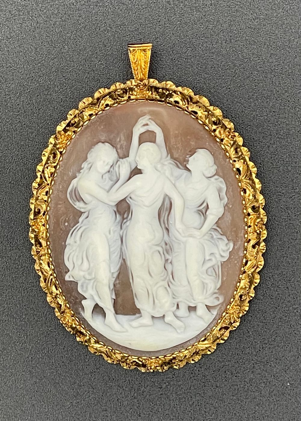 Lot 134 – Large Carved Shell Three Graces Cameo Pendant Brooch in 18 Karat Yellow Gold