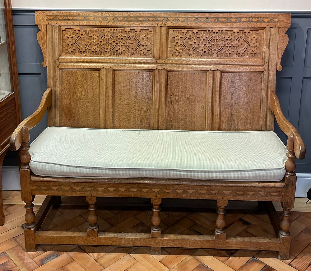 Lot 172 – An Arts And Craft Carved Oak Settle With Cushion Seat