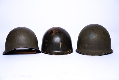 Set of 3 Army Helmets from the 1940s to the 1970s. The oldest helmet is from WWII and is a 