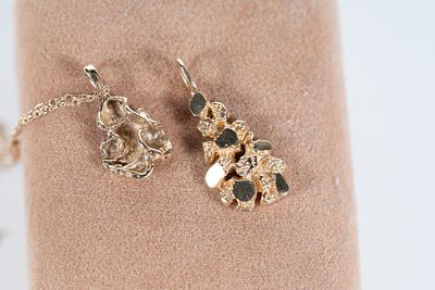 Pair of 14kt Gold Nugget Pendants. Pair of Gold Nugget Pendants. One pendant is on a gold 