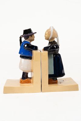 Pair of French Faience Henriot Quimper Figural Bookends. Depicts a man and a woman looking at 