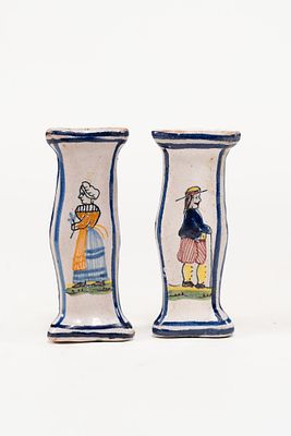 Pair of French Faience Knife Rests. Knife rests depict a man and a woman along with floral and 