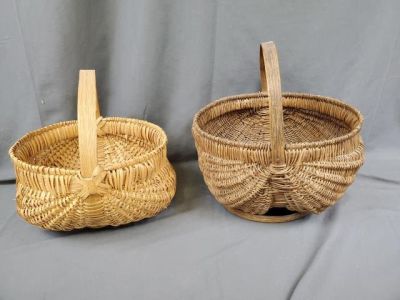 2 Antique Buttocks Baskets. Two antique buttocks baskets. Dark one measures 12 x 9 x 13 inches. 