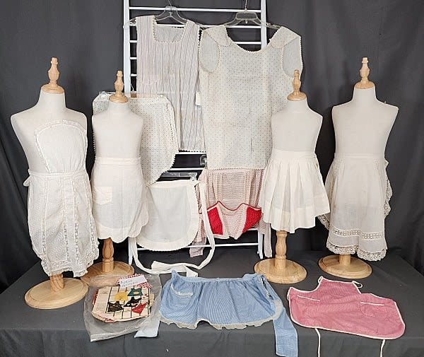 Lot 213: 11 Vintage Child Aprons and Pinafores