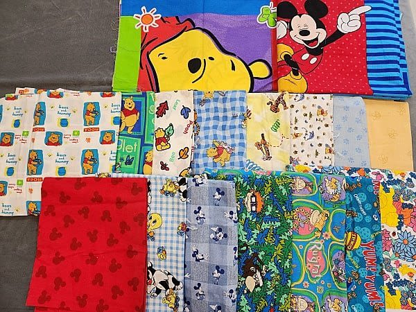 Lot 189: 11lbs of Quilt Fabrics- Disney, Pooh, and More