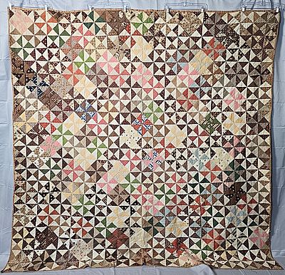 Antique c1860 Pinwheel Quilt measuring 87 by 90 inches. It is comprised of 231 pinwheel blocks 