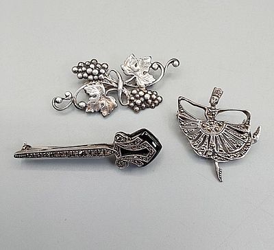 Trio of Vintage Sterling Brooches. The lot includes a trio of vintage sterling brooches.