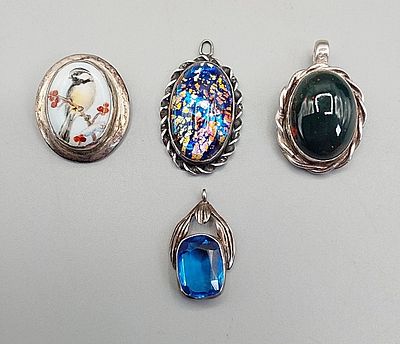 Group of 4 Vintage Sterling Pendants. The lot includes a group of 4 vintage sterling pendants.