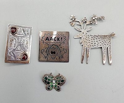 Group of 4 Sterling Brooches. The lot includes a mixed group of four sterling silver brooches.