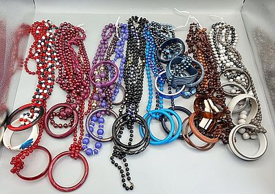 Beaded Necklaces and Bangle Bracelets. Grouping of colorful plastic beaded necklaces and bangle